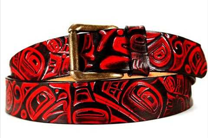 Handmade tooled and plain leather belts with snaps to change buckles